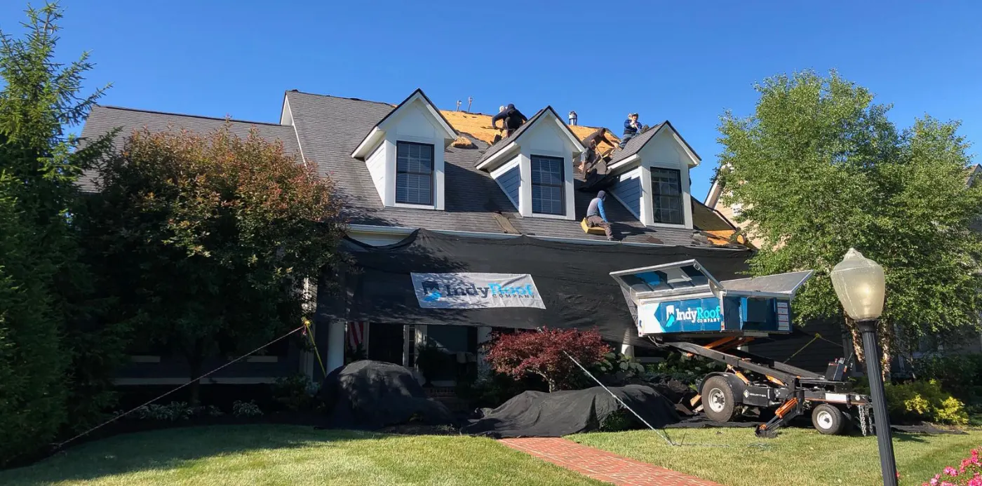 Emergency tarping on a Knollwood Farms roof